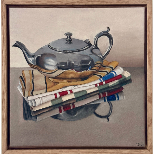 Silver Teapot and Tea Towel Stack