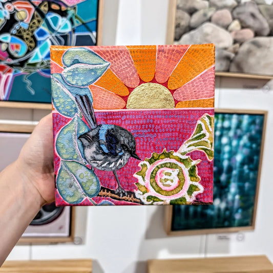 Blue boy with gum nuts and an orange sunset